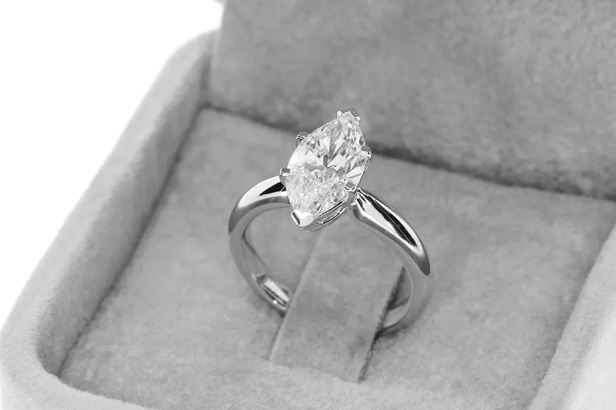 A marquise diamond engagement ring set in white gold.